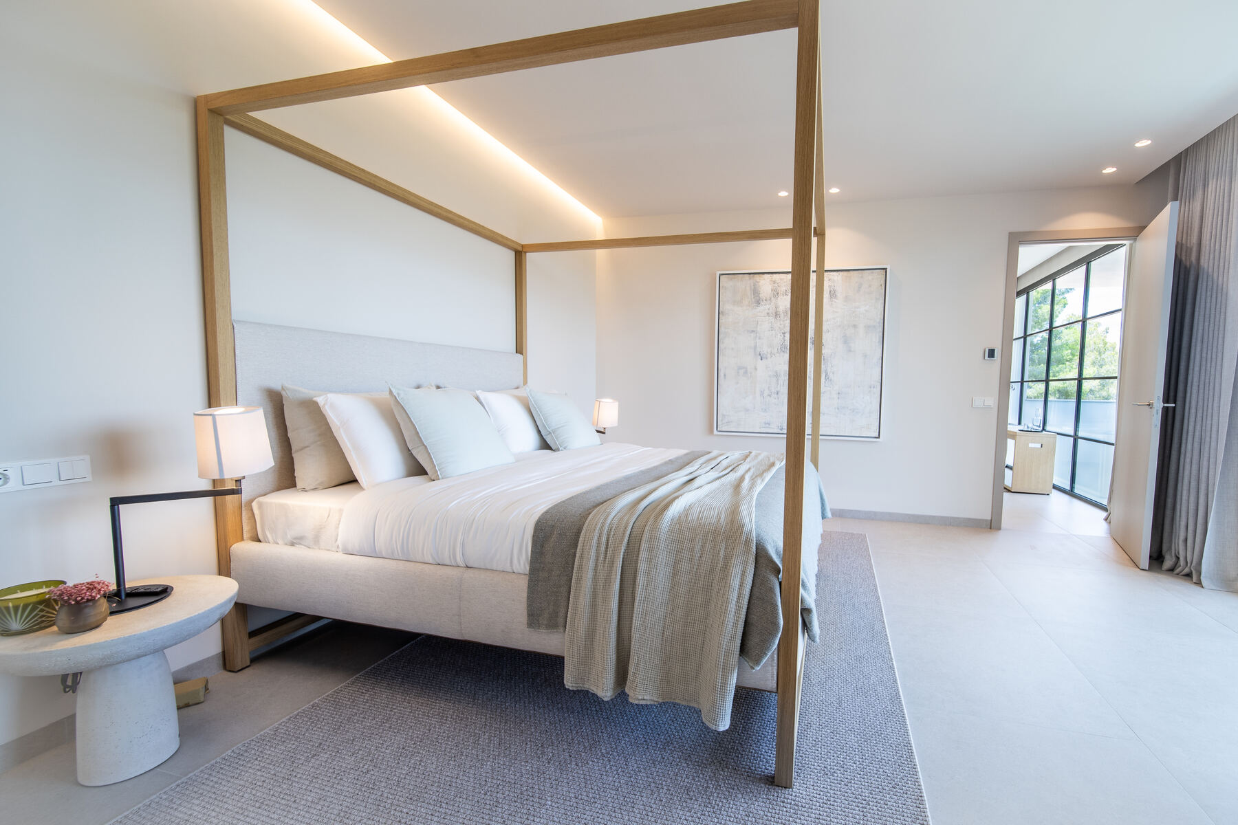 Bedroom with concealed cove lighting and a four-poster frame