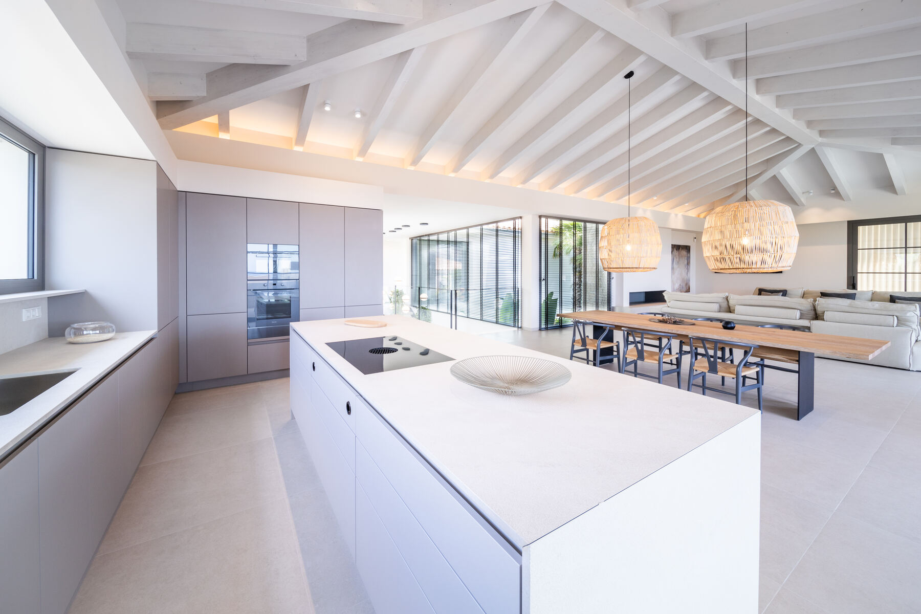 Open-plan kitchen and dining space with full-height glazing in a Mallorca villa